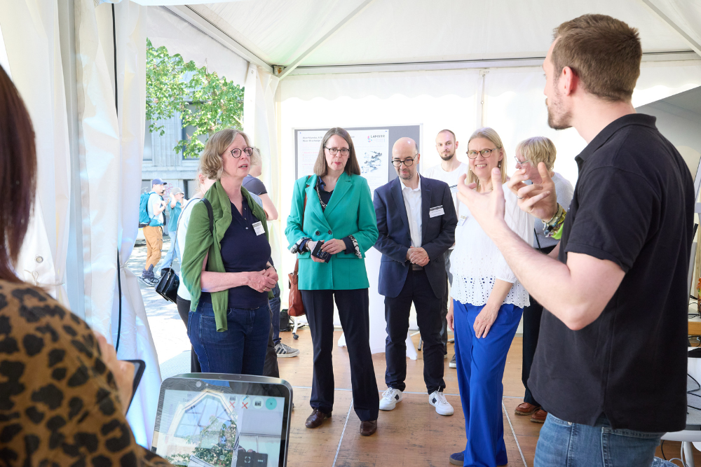 Representatives of the City of Bonn visit the joint AI tent at Bonn Science Night 2026 and discuss current research projects with researchers from the Lamarr Institute and partner institutions.