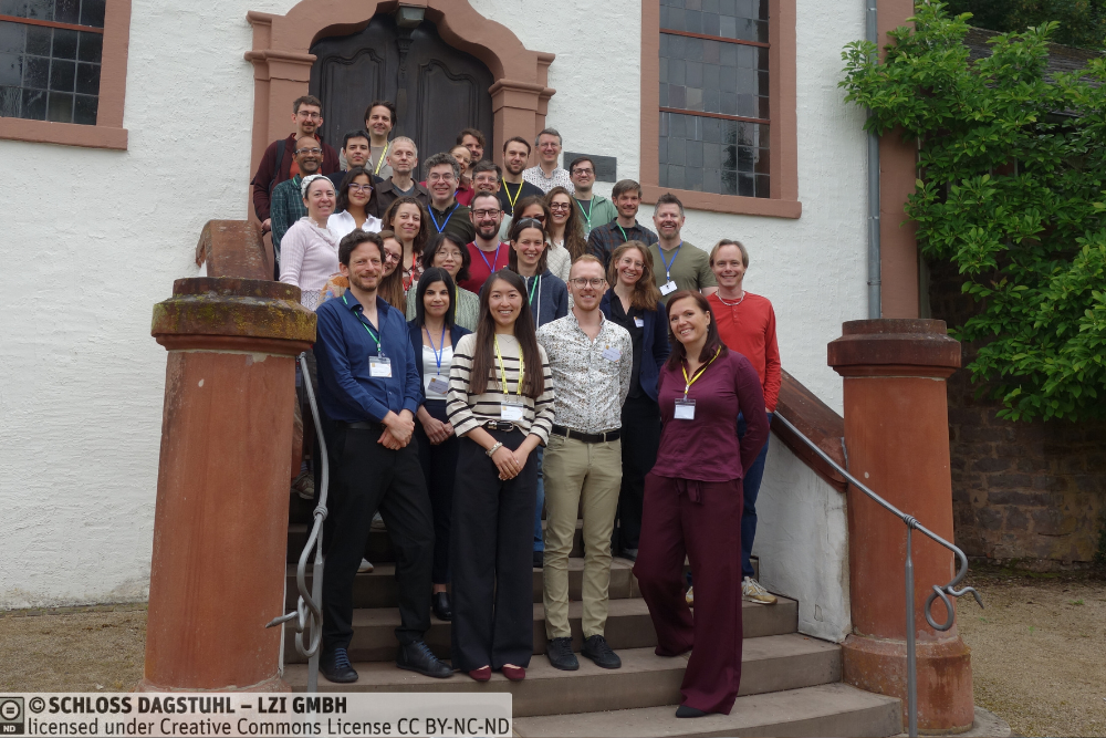 Group photo of international researchers participating in the Dagstuhl Seminar on Social Artificial Intelligence in front of Schloss Dagstuhl, Germany.