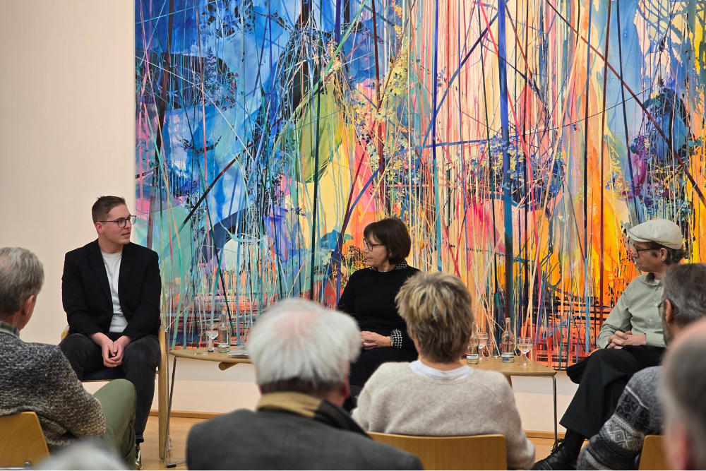 Photo. Panelists Matthias Jakobs, Martina Padberg and Achim Mohné in front of the audience.