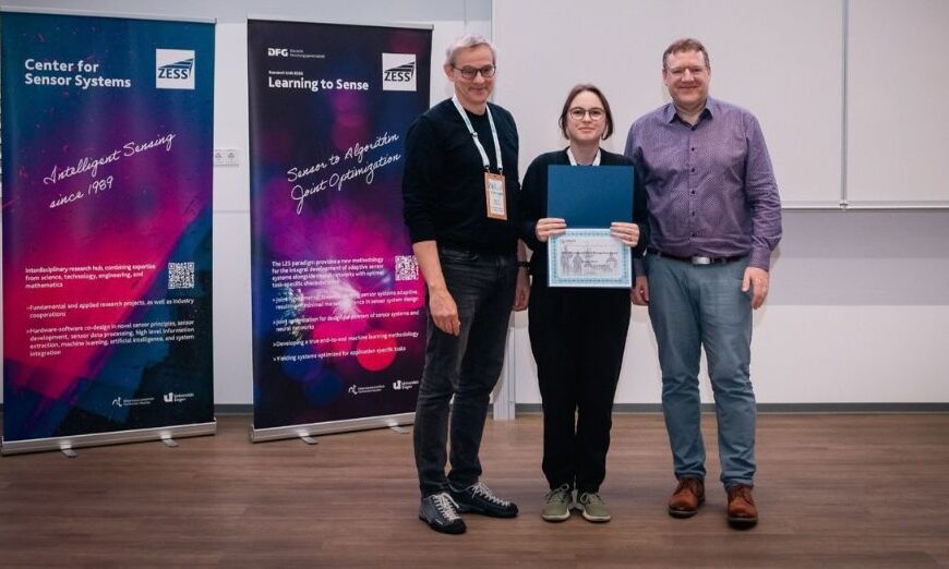 Zorah Lähner stands in the middle, holding a certificate and an award folder at DAGM GCPR 2026.