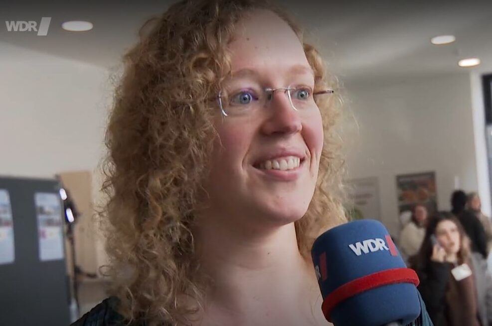 Prof. Dr. Lena Funcke during a WDR Lokalzeit interview at the University of Bonn, speaking about STEM outreach, AI research and inspiring young women in science